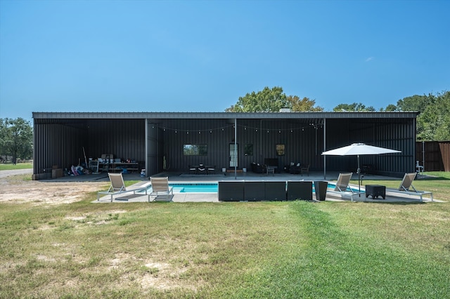 back of property with a patio area and a lawn