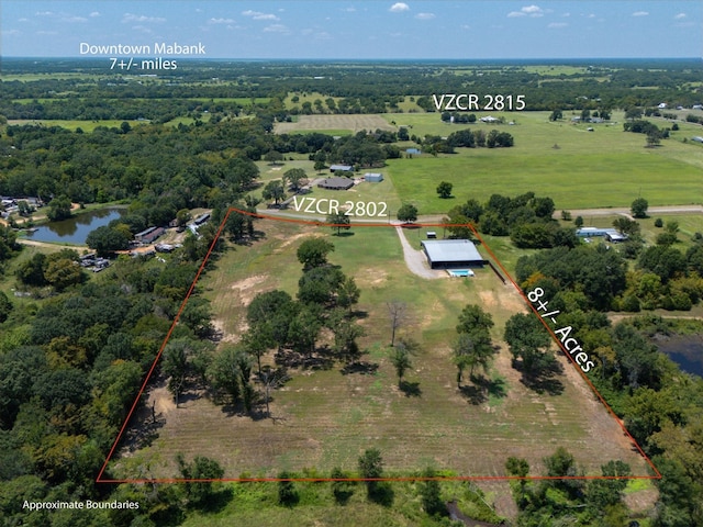 drone / aerial view featuring a water view and a rural view