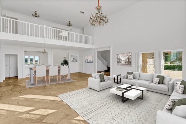 living room featuring a towering ceiling and a chandelier