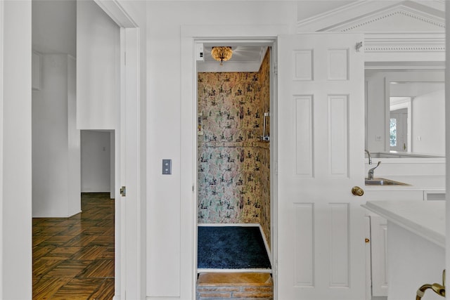 bathroom featuring vanity, parquet flooring, and ornamental molding