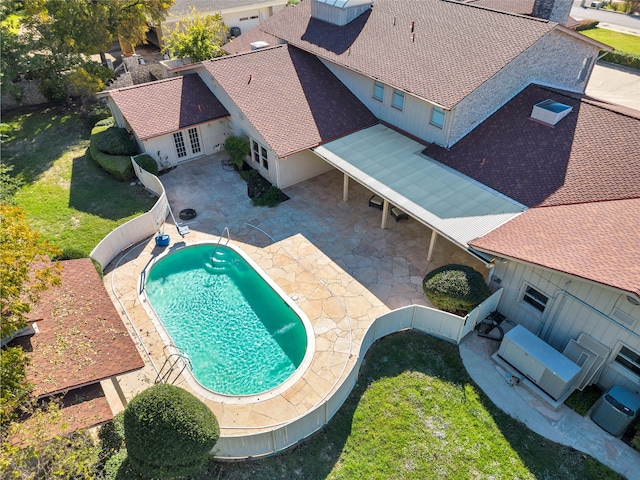 view of pool with a lawn and a patio