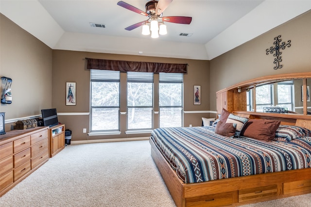 carpeted bedroom featuring multiple windows and ceiling fan