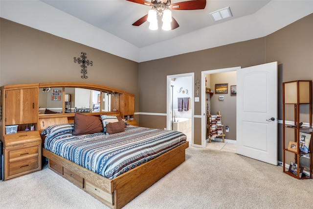 carpeted bedroom featuring ensuite bath and ceiling fan