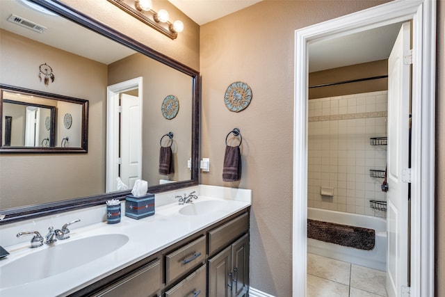 bathroom with tiled shower / bath, vanity, and tile patterned floors