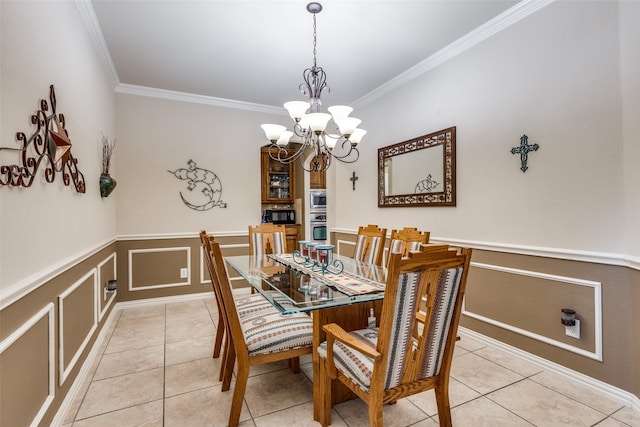 tiled dining space featuring crown molding and an inviting chandelier