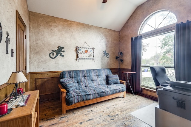 home office featuring lofted ceiling, hardwood / wood-style flooring, and plenty of natural light