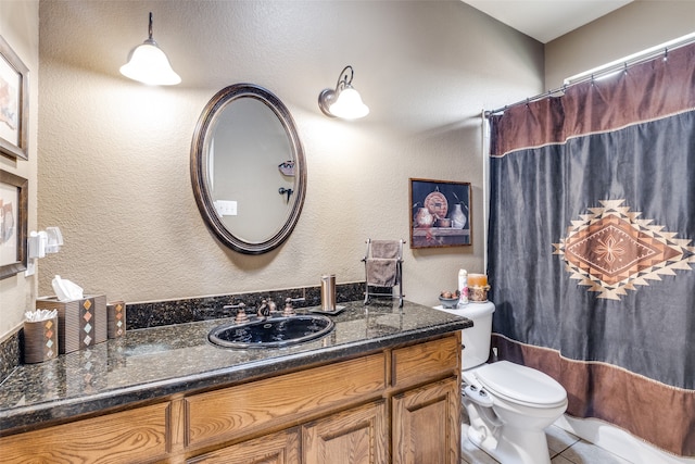 bathroom with vanity, toilet, and tile patterned flooring