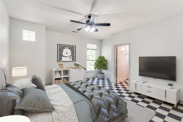 bedroom featuring ceiling fan and ensuite bath