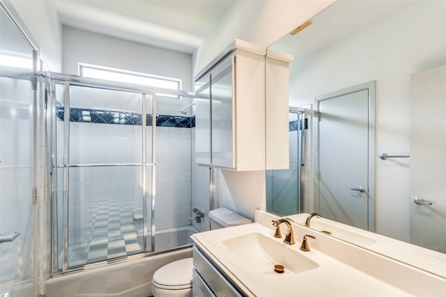 full bathroom with toilet, vanity, and enclosed tub / shower combo