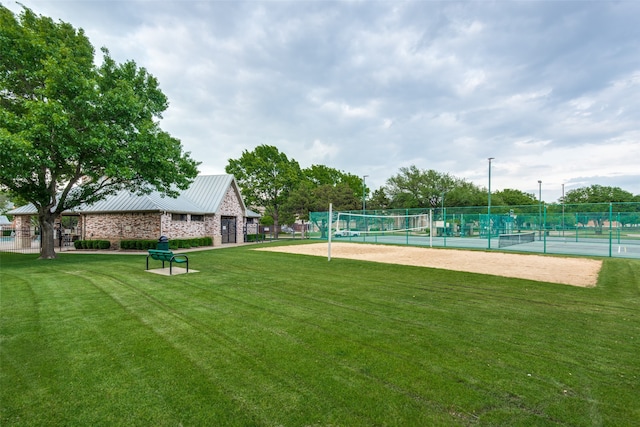 view of community with a lawn, volleyball court, and tennis court