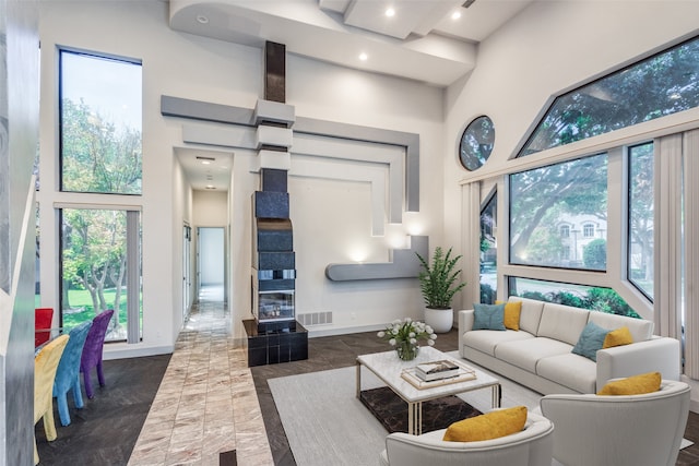 living room with a healthy amount of sunlight and a towering ceiling