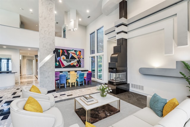 living room featuring a towering ceiling