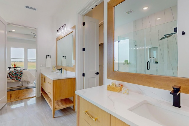 bathroom with vanity, an enclosed shower, and hardwood / wood-style flooring