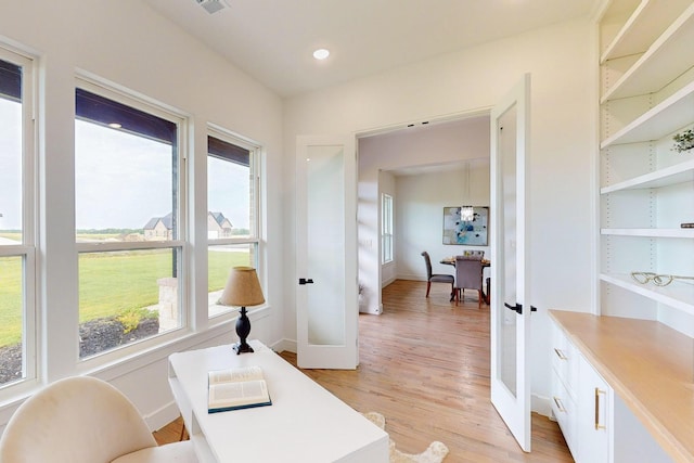 office space featuring light hardwood / wood-style floors and french doors