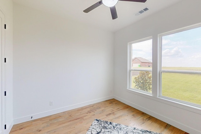 empty room with light hardwood / wood-style floors and ceiling fan