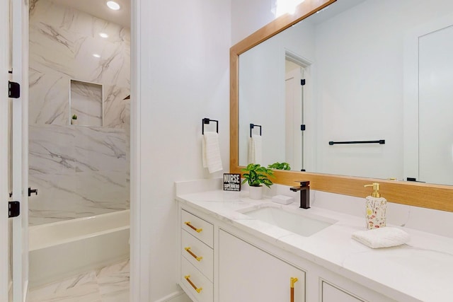 bathroom featuring vanity and tiled shower / bath combo