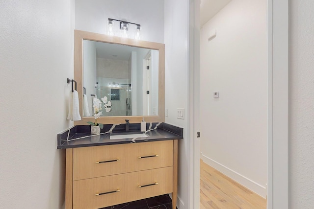 bathroom with an enclosed shower, hardwood / wood-style flooring, and vanity