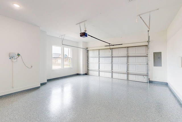 garage with a garage door opener and electric panel