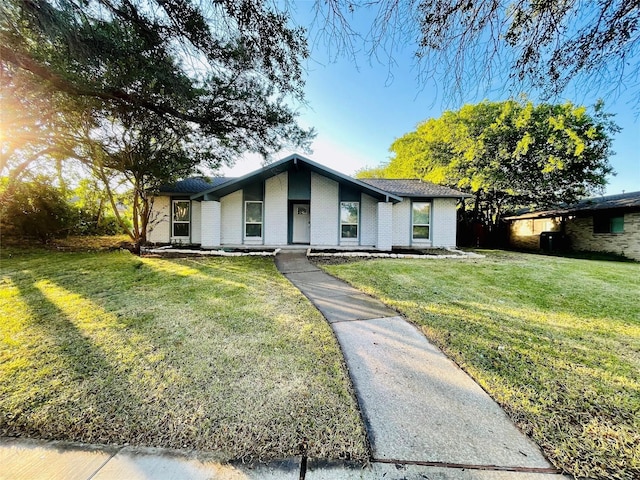 1517 W Spring Creek Pkwy, Plano, TX 75023 - mid-century home featuring a front lawn and brick siding