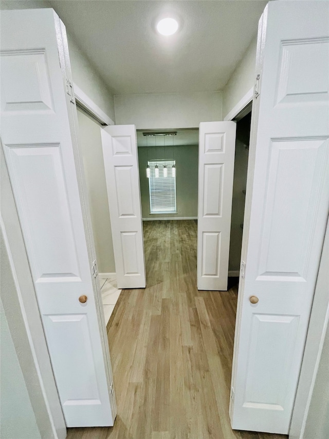 hall with light hardwood / wood-style flooring