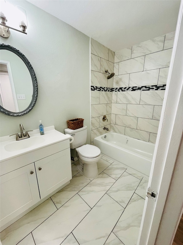 full bathroom featuring tiled shower / bath, vanity, toilet, and tile patterned flooring