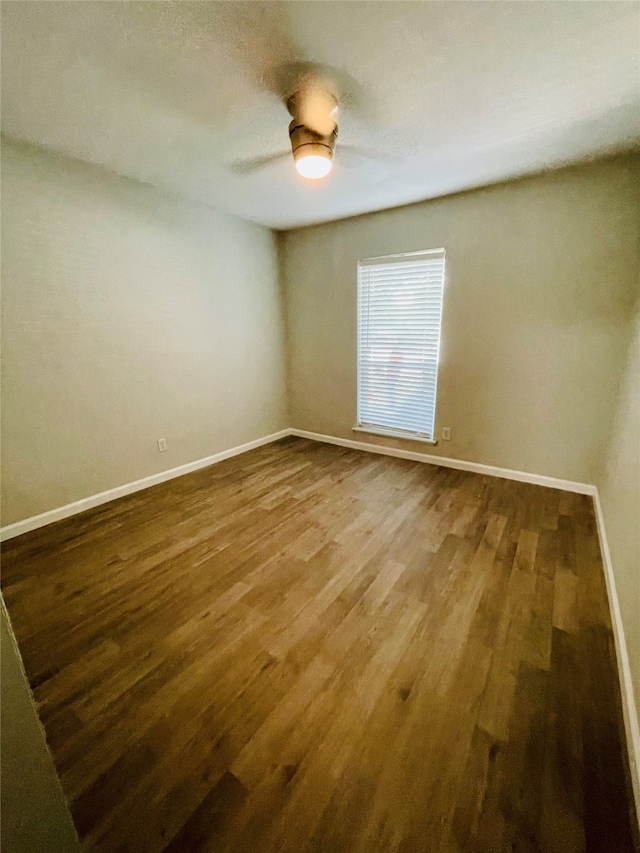 spare room with ceiling fan and wood-type flooring