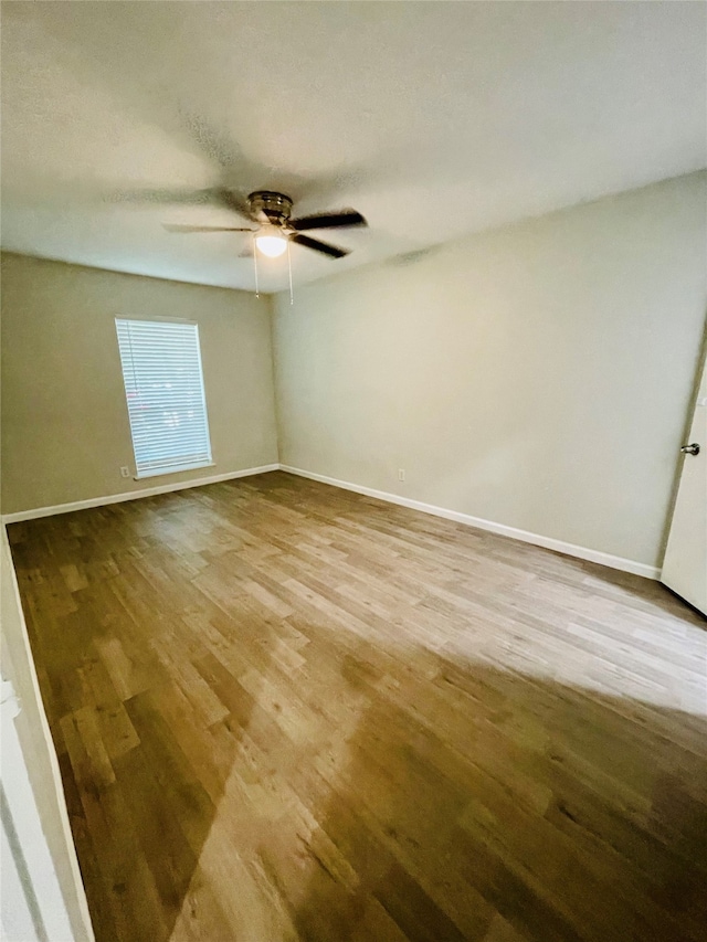 spare room featuring ceiling fan and hardwood / wood-style flooring