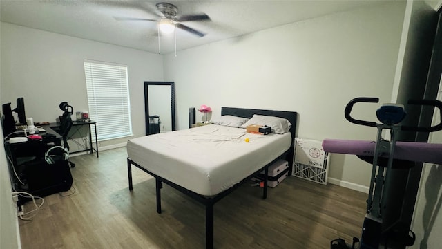 bedroom with dark hardwood / wood-style flooring and ceiling fan