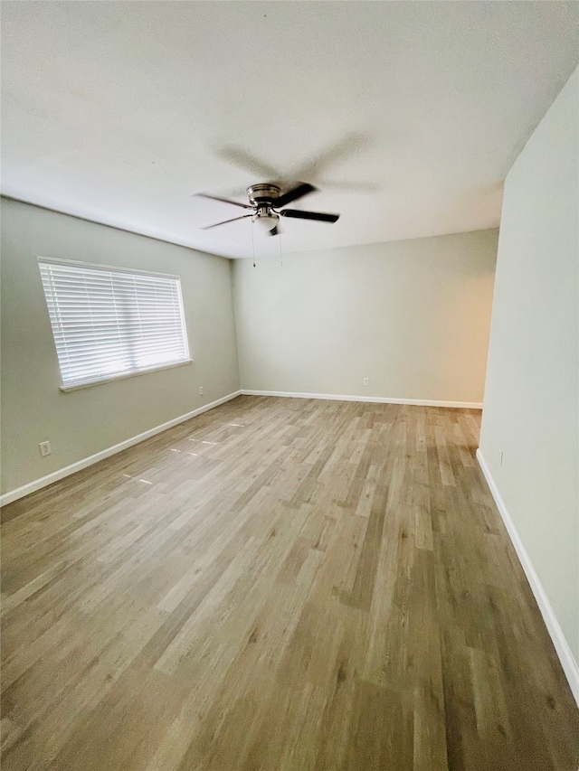 spare room with ceiling fan and light hardwood / wood-style floors