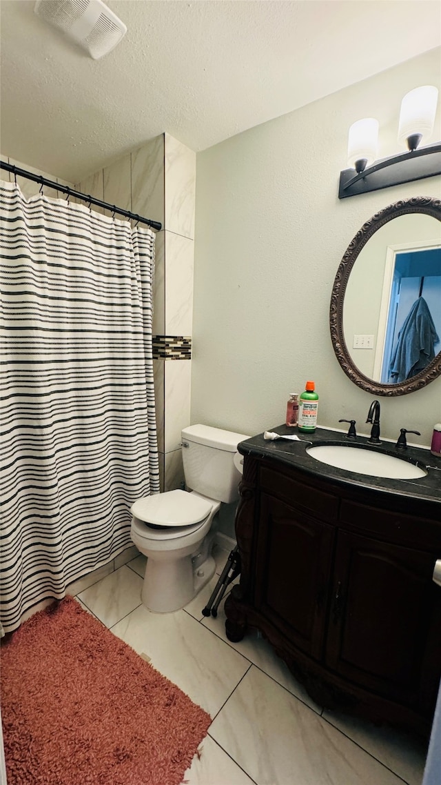 bathroom featuring curtained shower, tile patterned flooring, toilet, vanity, and a textured ceiling