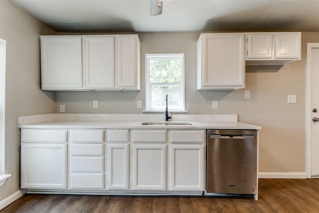 kitchen with dark wood-type flooring, white cabinets, stainless steel dishwasher, and sink