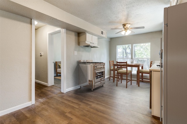 kitchen featuring a textured ceiling, white cabinets, dark hardwood / wood-style flooring, ceiling fan, and high end stainless steel range oven