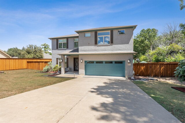 front of property featuring a front yard and a garage