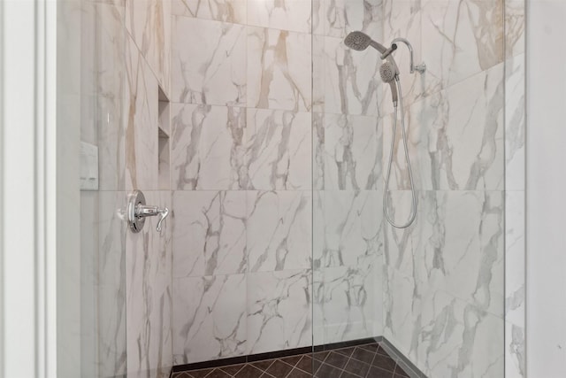 interior details featuring a marble finish shower