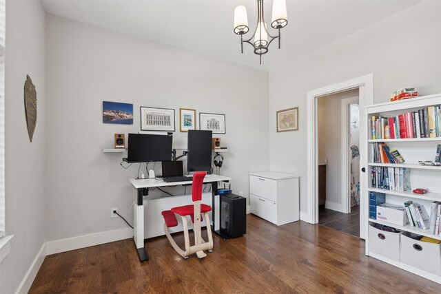 home office with a notable chandelier and dark hardwood / wood-style floors