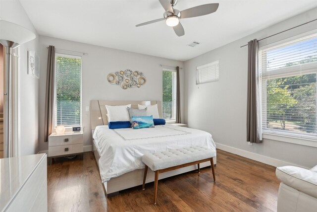 bedroom with ceiling fan and dark hardwood / wood-style floors