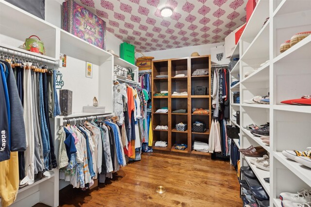 spacious closet featuring hardwood / wood-style floors