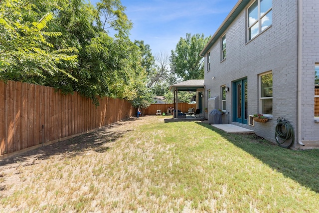 view of yard with a fenced backyard and a patio