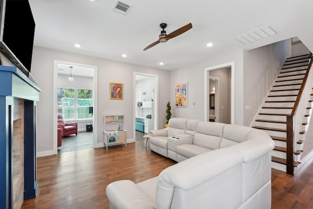 living room with stairway, visible vents, wood finished floors, and recessed lighting