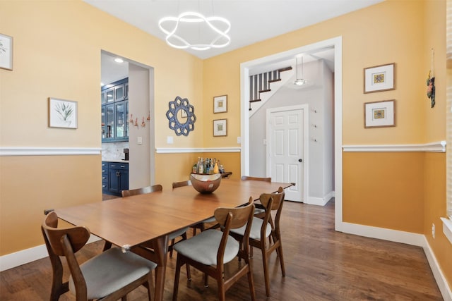 dining room with dark wood-style floors and baseboards