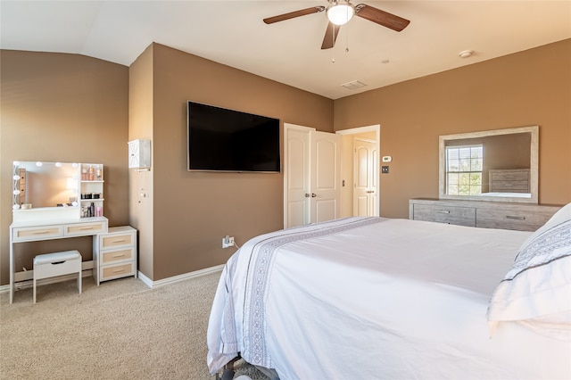 carpeted bedroom with ceiling fan and vaulted ceiling