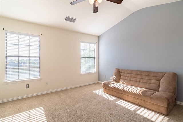 sitting room with lofted ceiling, ceiling fan, and light colored carpet