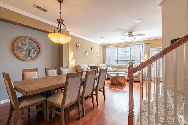 dining room featuring wood-type flooring, ceiling fan, and ornamental molding