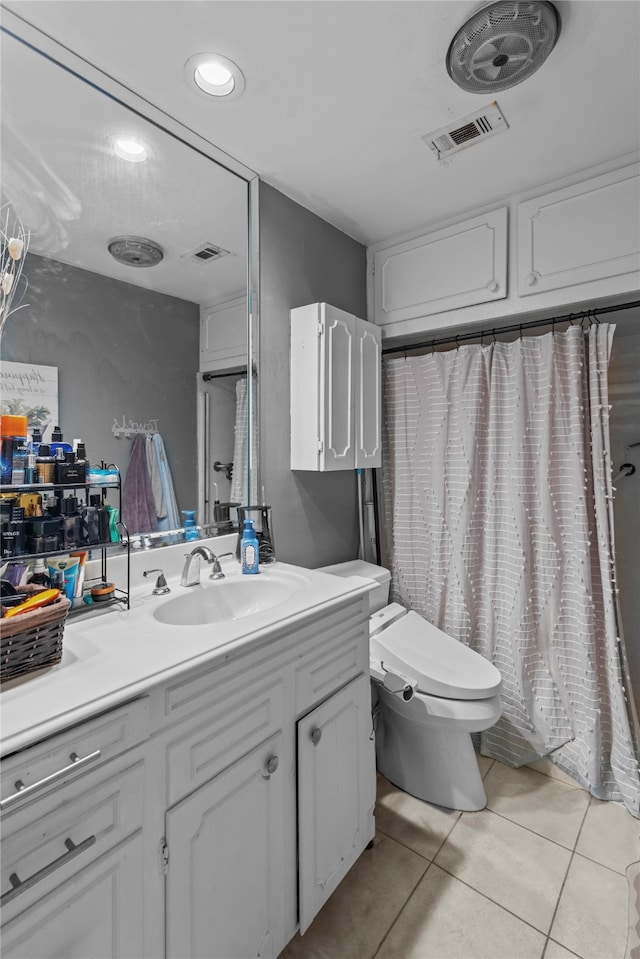 bathroom featuring vanity, toilet, and tile patterned flooring