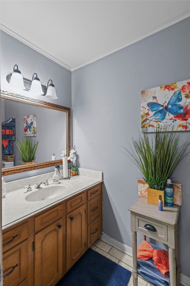 bathroom featuring tile patterned flooring, vanity, and crown molding