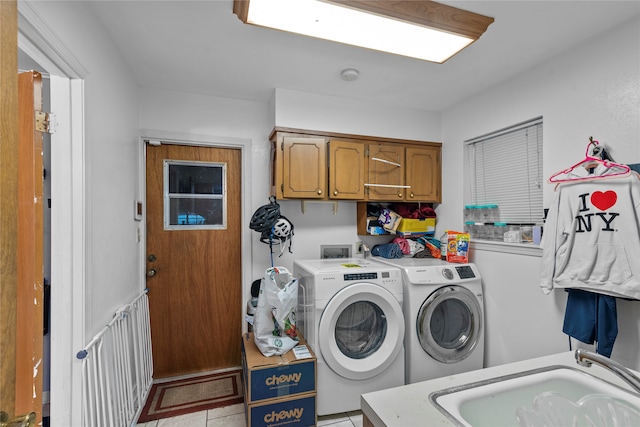 washroom featuring cabinets, sink, independent washer and dryer, and light tile patterned flooring