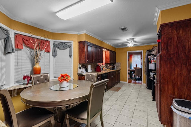 dining space with ceiling fan, light tile patterned floors, and ornamental molding