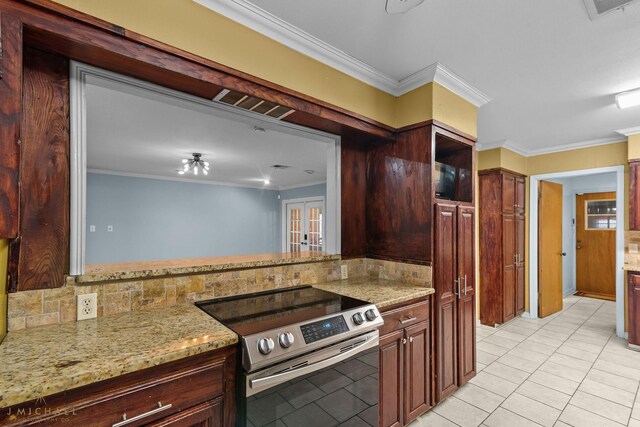 dining area with ornamental molding and light tile patterned floors