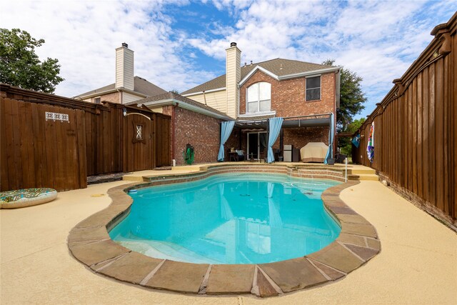 view of swimming pool featuring a patio area