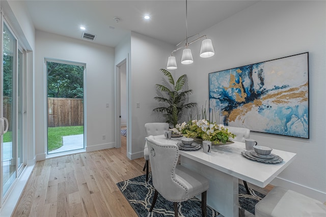 dining area with light hardwood / wood-style floors and plenty of natural light